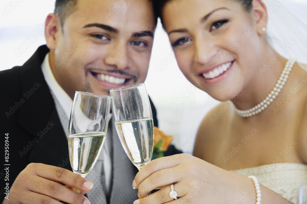 Multi-ethnic bride and groom toasting